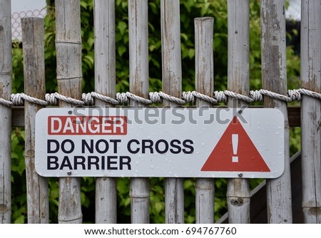 Danger do not cross barrier sign