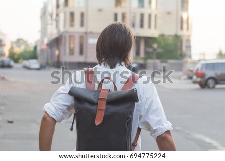 close up picture of man with leather backpack