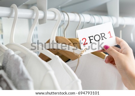 2 for 1 and two for one offer and special deal for t-shirt  Royalty-Free Stock Photo #694793101
