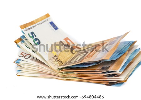 Wad of euro bills banknotes cash on table.