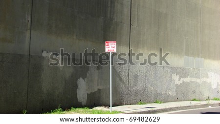 no stopping sign with concrete wall background