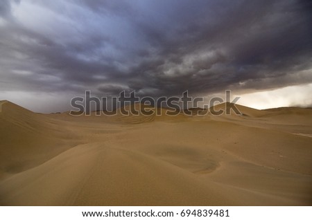china gansu Crecent Lake,on the desert.it was a desert storm. Royalty-Free Stock Photo #694839481