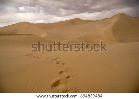 china gansu Crecent Lake,on the desert.it was a desert storm. Royalty-Free Stock Photo #694839484