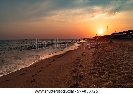 Holiday vacation travel concept: Summer holiday vacation Sunset beach Titreyengol. Antalya. Turkey. Sea sunset beach landscape