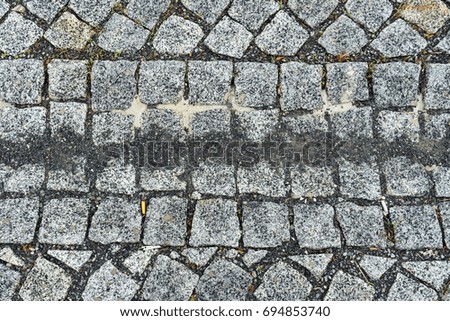 Gray square stones paved road. Abstract background, texture image
