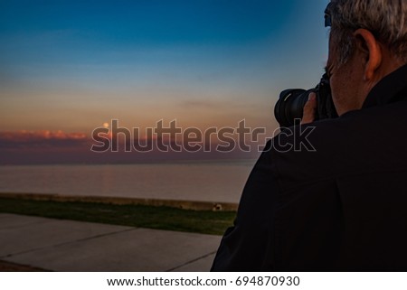 Male Photographer Sunset Moon over Water