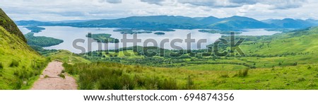 Panoramic sight from Conic Hill, Balmaha, village on the eastern shore of Loch Lomond in the council area of Stirling, Scotland. Royalty-Free Stock Photo #694874356