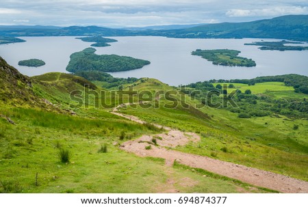 Panoramic sight from Conic Hill, Balmaha, village on the eastern shore of Loch Lomond in the council area of Stirling, Scotland. Royalty-Free Stock Photo #694874377
