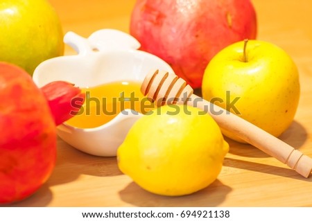 Beautiful fresh fruit and honey composition for the Jewish New Year (Rosh Hashana) holiday concept.
