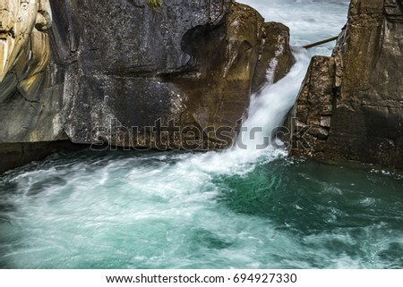 Bow river at Johnston Canyon, Alberta, Canada. High stream water background, forest, Mountains. Blue Water, Cold water. River between Cliffs