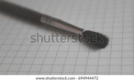 A brush on paper in a cell. Background