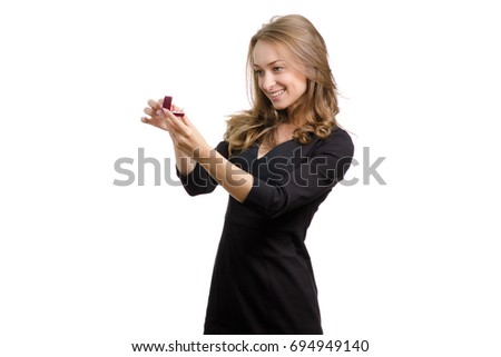 Young woman with a ring in a box on a white background isolation offer