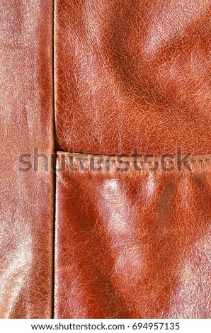 Brown leather texture. Useful as background for any design work. Macro photography of outerwear made of genuine leather