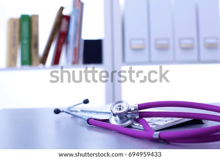 Medical stethoscope lies in the study on the table