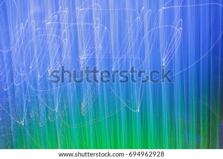 Light neon painting photography - fairy blue and green lights in swirl and waves pattern, ripples and loops, striped lines in motion - abstract concept, photo effect - long exposure