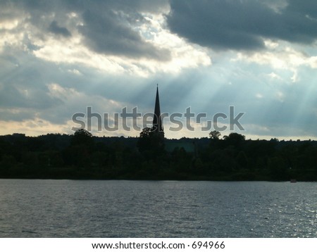 church spire silhouette with sun rays
