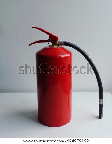 red fire extinguisher on white background