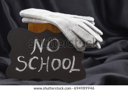 Announcement of NO SCHOOL on chalkboard notifies of winter weather closing.