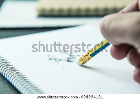pencil eraser with eraser dust on notebook,mistake concept