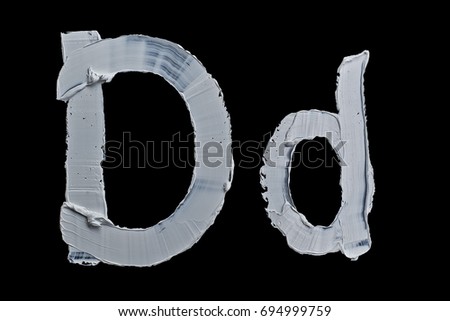 Alphabet.Oil  White oil paint.Letter D on a black background