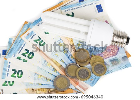 Light Bulb electric lamp on european banknotes. Concept of cost price of electricity and saving electricity with modern lamp. On white background