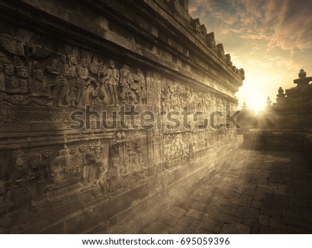 Picture  of old ancient relief on the wall of Borobudur temple, shot at sunset time