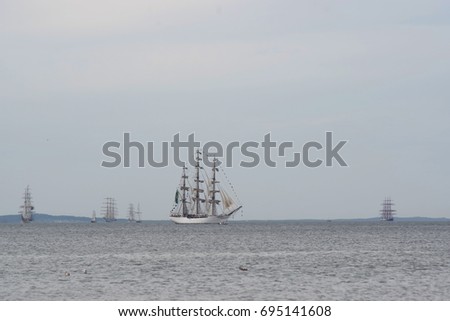 flowing on sea sailing-ship on sky background