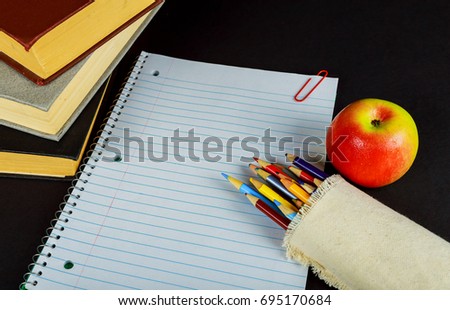 back to school concept isolated on black background Blank Notebook, Pencil, Pen, Ruler and Scissors on Wooden Background