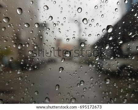 Sitting behide raindrop glass in rainy day 