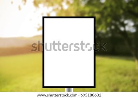 Blank standing sign with copy space for text message or mock up content in Abstract background of lawn blur with soft light