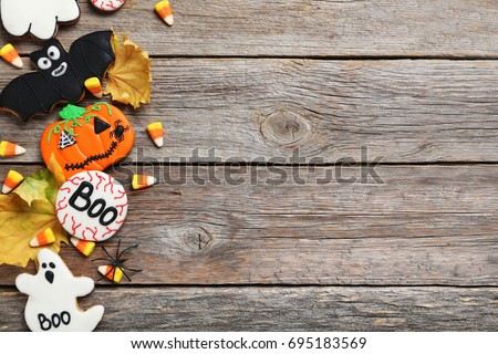 Fresh halloween gingerbread cookies on grey wooden table
