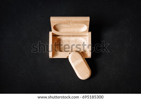 Packaging for USB drives. Wooden box with USB-stick for a photographer, on a dark background. Top view. Soft focus