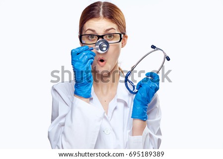 Doctor woman holding a stethoscope by the nose on an isolated background portrait                               