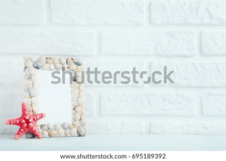 Frame of sea shells on the brick wall background