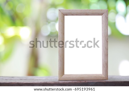 Modern Picture Frame placed on a wooden floor hand have copy space to work input your idea.