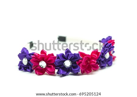 Floral hair scarf or hair comb for girls isolated on white background. selective focus shot Royalty-Free Stock Photo #695205124