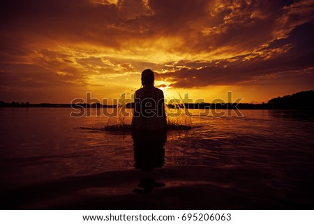 silhouette of woman at sunset. colorful dawn