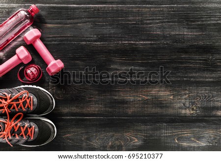 Sneakers dumbbells and a bottle of water. Flat view. All in one color.
