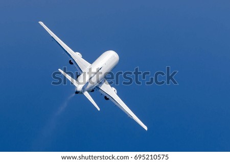 White airplane takes off in the rain in the blue sky