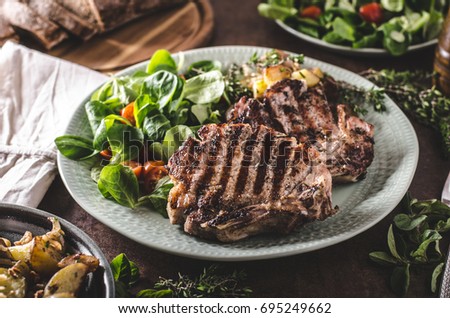 Grilled pork chops with with salad and potato salad