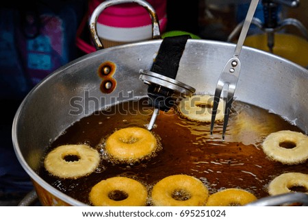 Frying donut in pan, Thailand. How to eat with sugar.