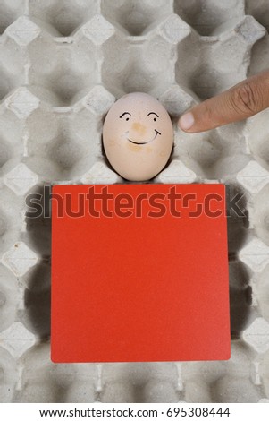 Cartoon face expression at egg and red board with finger