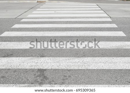 Pedestrian crossing on an old asphalt road