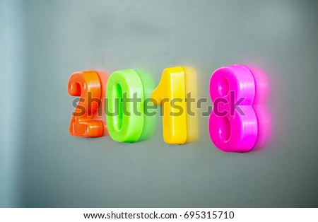 Colorful magnet number 2018 on grey background. alphabet 2018  for xmas and  happy new year 2018 concept.. image for background, wallpaper and greeting card