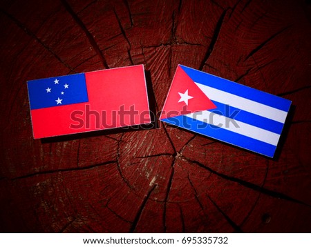 Samoa flag with Cuban flag on a tree stump isolated