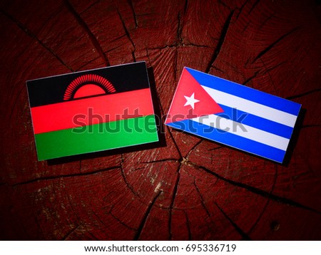 Malawi flag with Cuban flag on a tree stump isolated