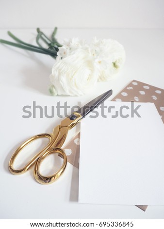 Styled stock photo. Feminine digital product mockup with buttercup and daffodil flowers, blank list of paper and golden scissors. White background. Flat lay image, top view. 