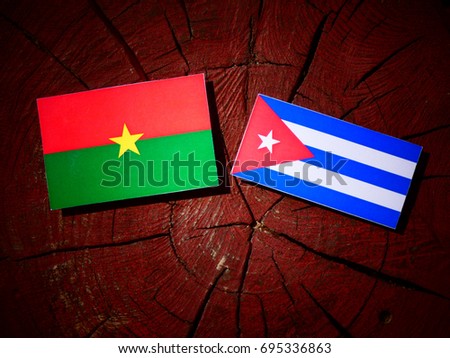 Burkina Faso flag with Cuban flag on a tree stump isolated