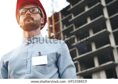 Young modern engineer builder with empty blank badge on his chest