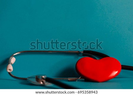 Red heart and stethoscope on table, world health day and healthcare concept.